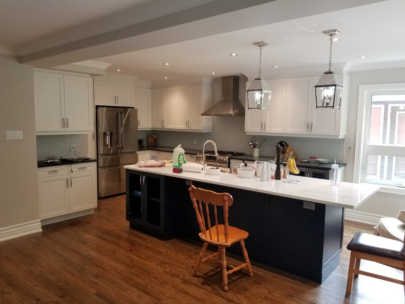 Finished kitchen with a white quartz island and pendant lights