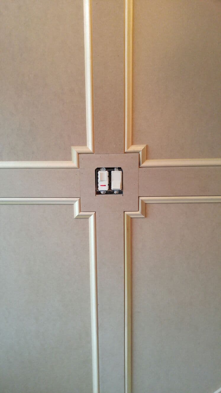 Wainscoting detail fitted around a light switch